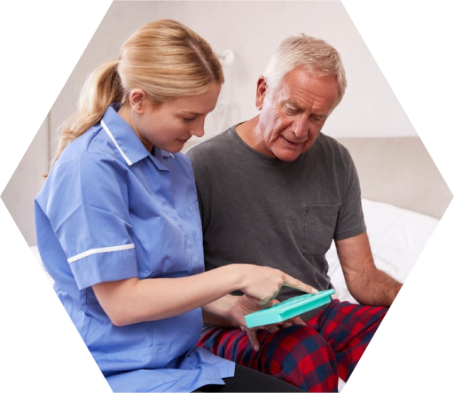 A nurse and an older man are looking at something.